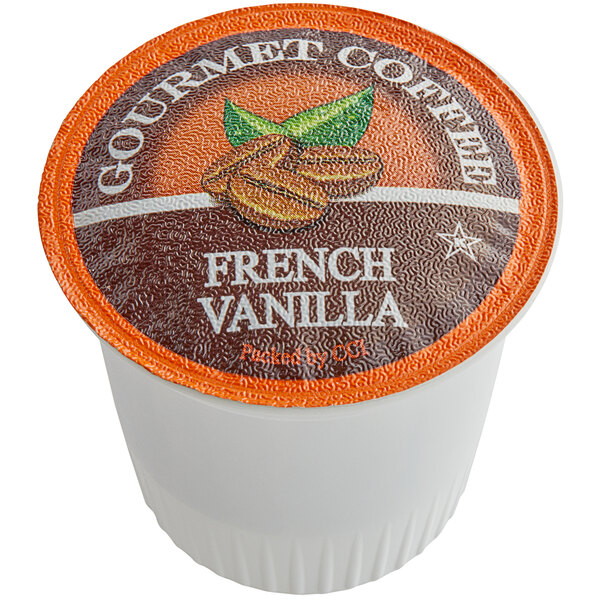 A Caffe de Aroma French Vanilla Coffee single serve cup in orange and white packaging.