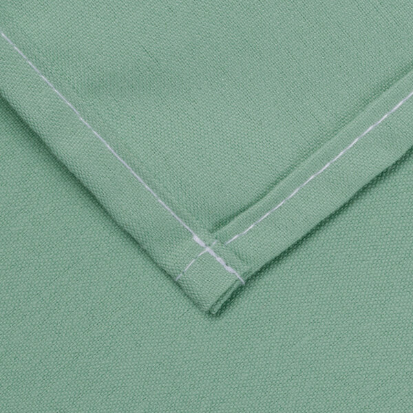 A seafoam green rectangular cloth table cover with white stitching.