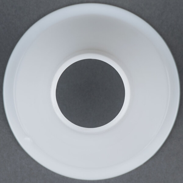 A white plastic circle with a hole in it.