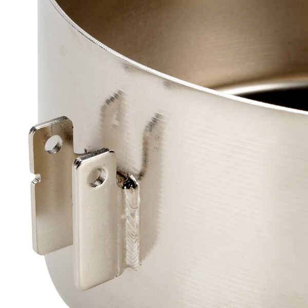 A close-up of a metal container with two metal clips.