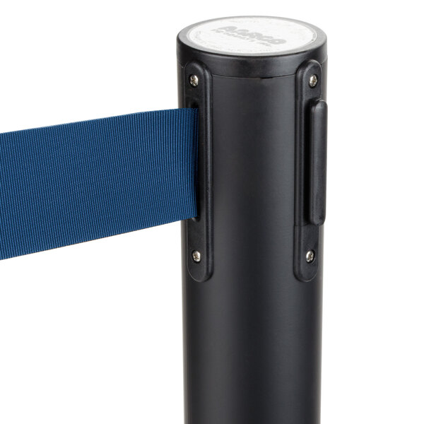 A black Aarco crowd control stanchion with a blue retractable belt.