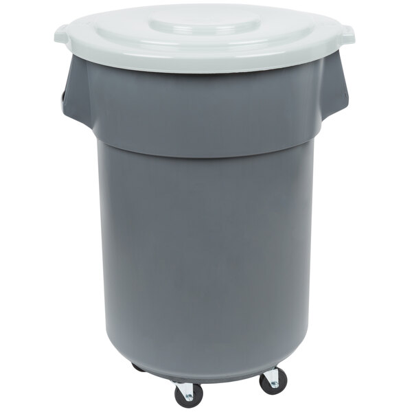 A grey plastic trash can with wheels and a white lid.