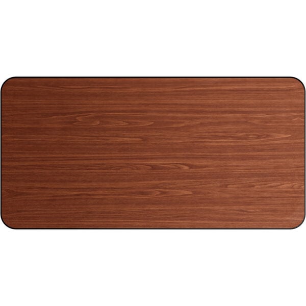 A Lancaster Table & Seating rectangular table top with a reversible walnut and oak wood surface and black edges.