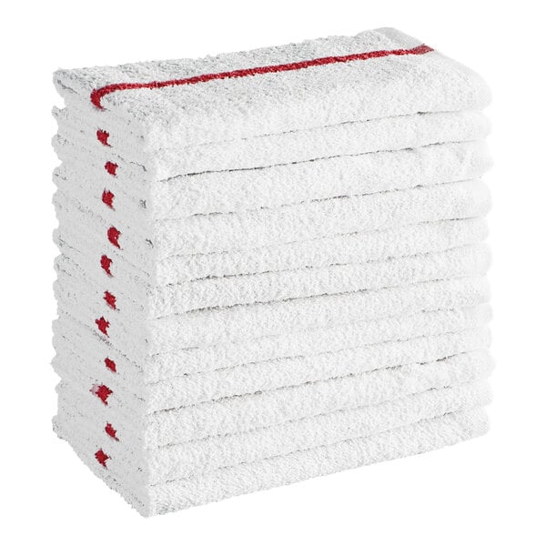 A stack of twelve white towels with a red stripe along the edge.