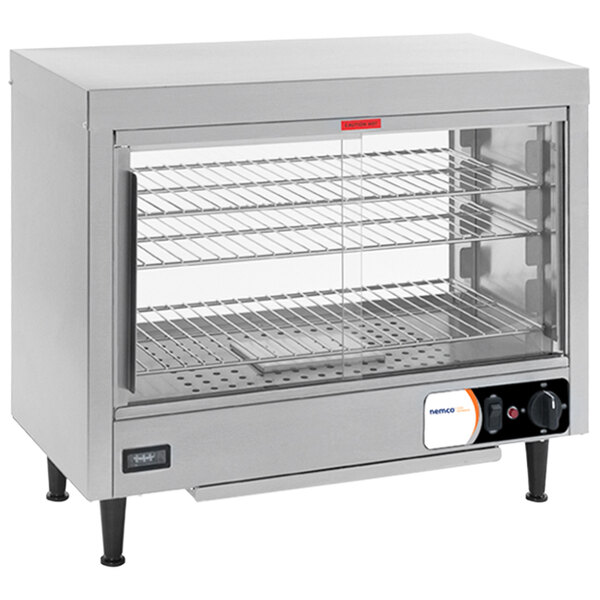 A stainless steel Nemco countertop heated display case with a glass door.