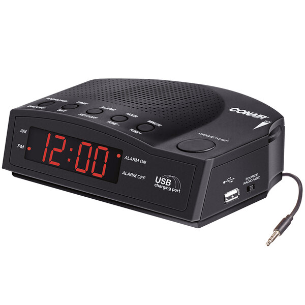 A black Conair alarm clock radio with a digital display and red numbers.