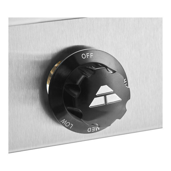 A black control knob on a stainless steel panel for a hot food table.