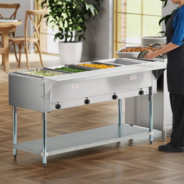 A four-pan electric steam table with an undershelf, designed for keeping food warm in a commercial setting.