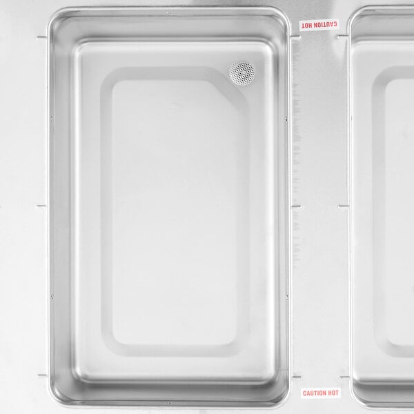 A stainless steel four pan electric hot food table with a sealed well and undershelf.