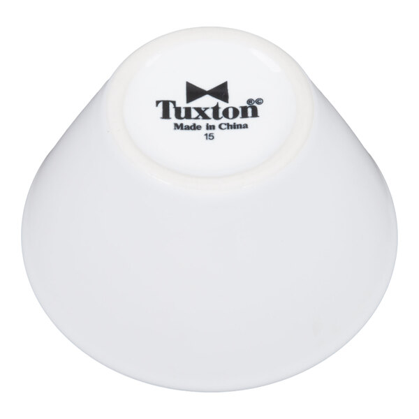 A white 8 oz. china bouillon cup with the Tuxton logo on the bottom.