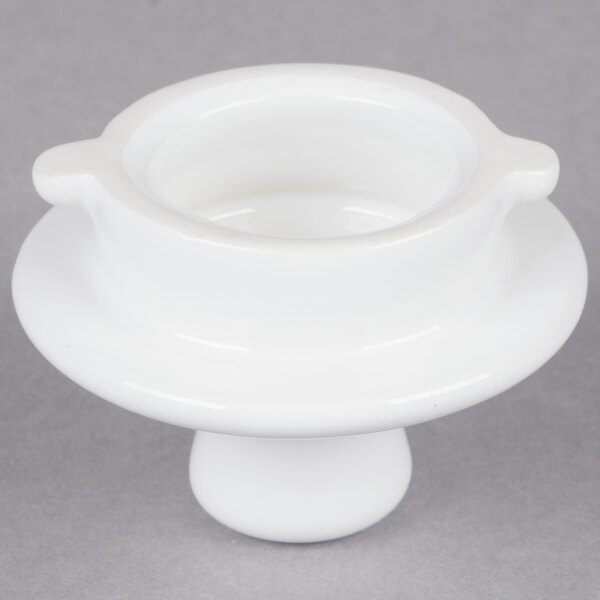 A white Tuxton China teapot lid with a round base and a silver handle.