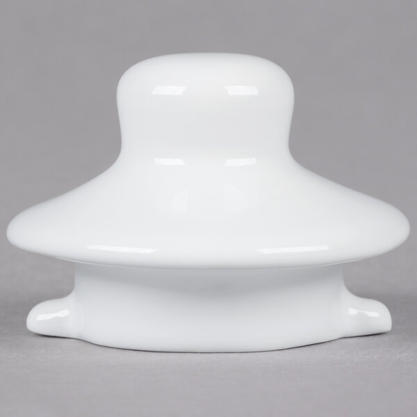 A white China teapot lid with a white plastic knob on top.