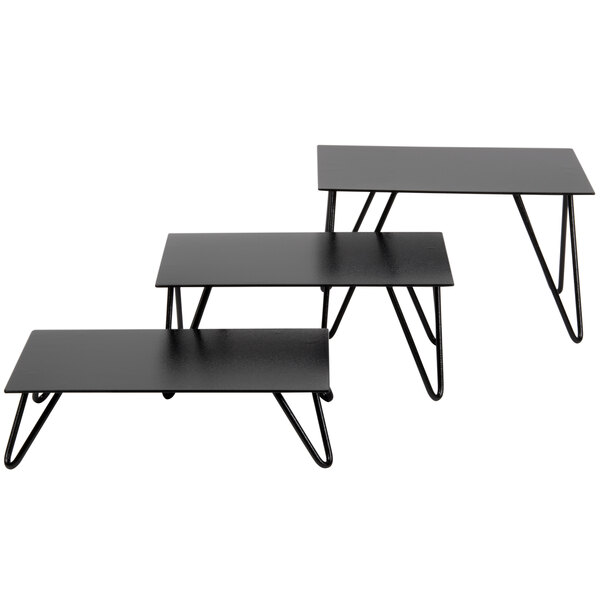 A black Cal-Mil rectangular metal riser set with V-shaped legs.