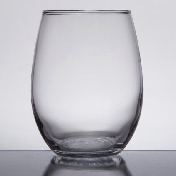 An Arcoroc stemless wine glass on a table.