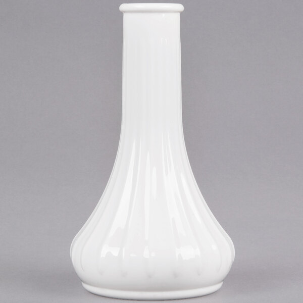 A white Cambro bud vase with a curved bottom on a gray surface.