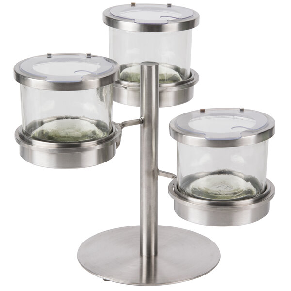 A stainless steel tiered display stand for three 16 oz. clear glass jars with notched lids.