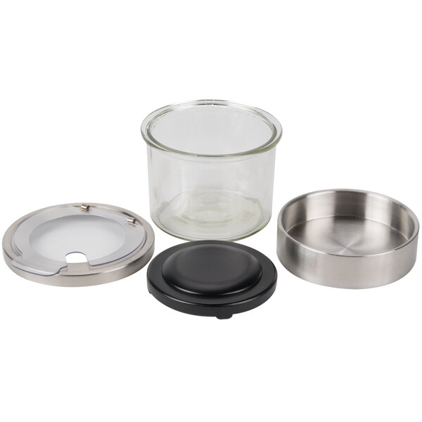 A Cal-Mil tiered display with glass jars and stainless steel notched lids on a counter.