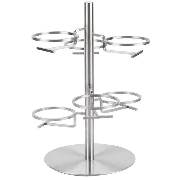 A metal Cal-Mil stand with four circular rings on it.