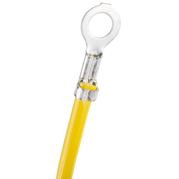 A yellow cable with a round metal ring.