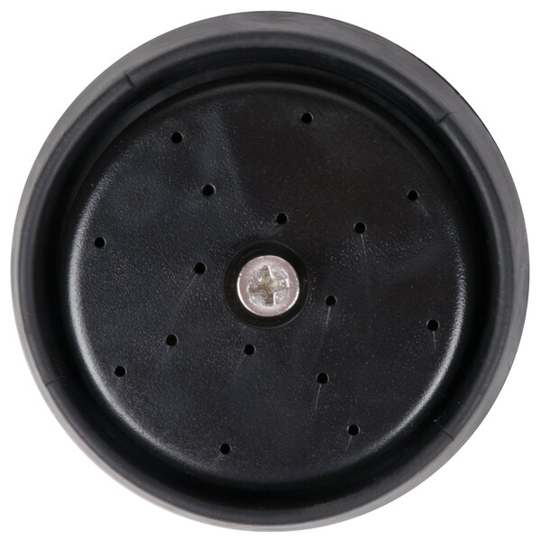 A black round plastic object with holes.