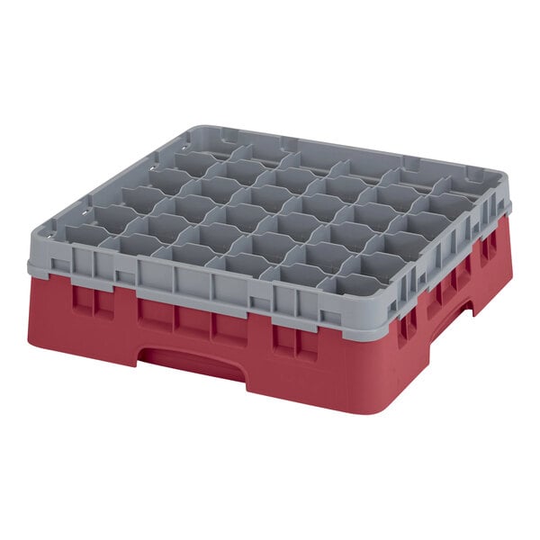 A red plastic Cambro glass rack with many compartments.