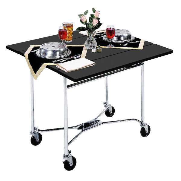 A Lakeside black room service table with food, drinks, and a vase of pink flowers.