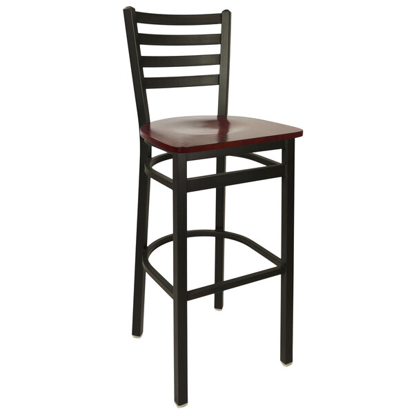 A BFM Seating Lima metal ladder back barstool with a mahogany wooden seat.