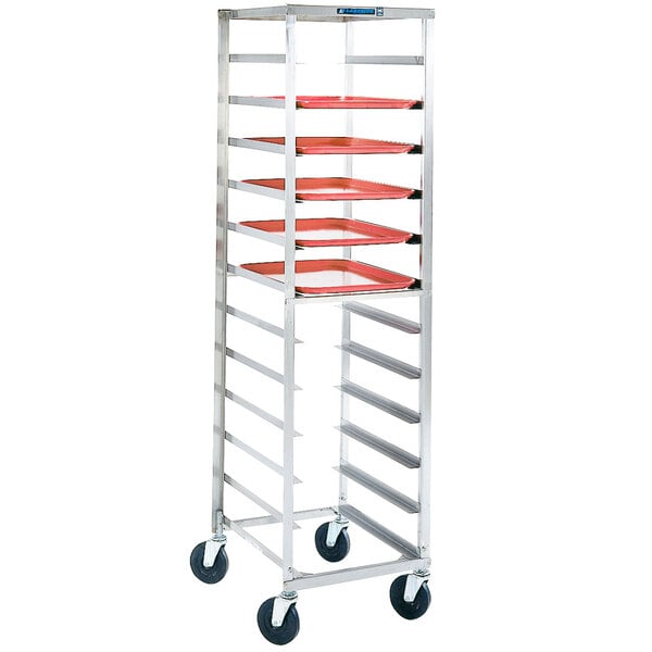 A Lakeside stainless steel sheet pan rack with red trays on it.
