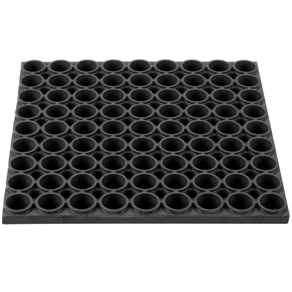 A black Notrax anti-fatigue rubber mat with holes in it.