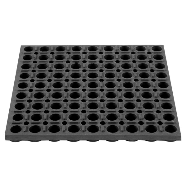 A black rubber mat with holes.