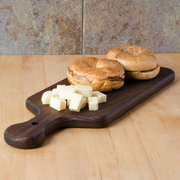 An American Metalcraft ash wood serving board with bagels and cheese on it.