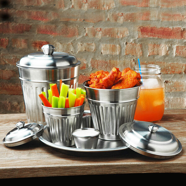 An American Metalcraft mini stainless steel trash can lid on a metal container full of vegetables.