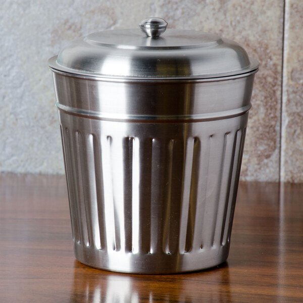 A close-up of a silver American Metalcraft mini stainless steel trash can lid.