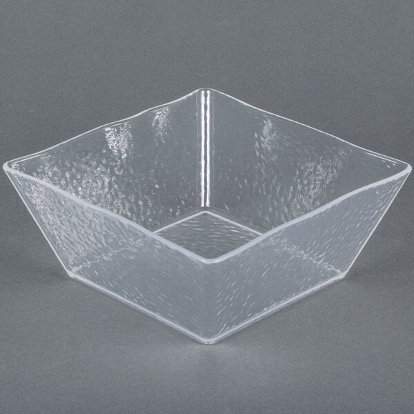 A close up of a clear square styrene bowl with a rain-splashed design.