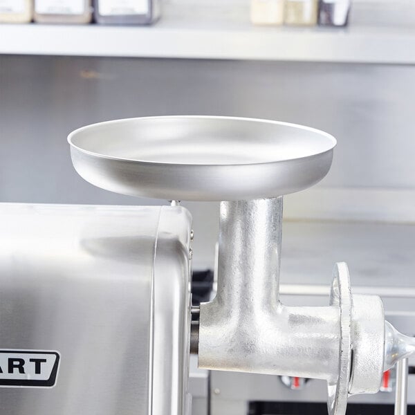 A stainless steel round feed pan for a Hobart meat grinder.