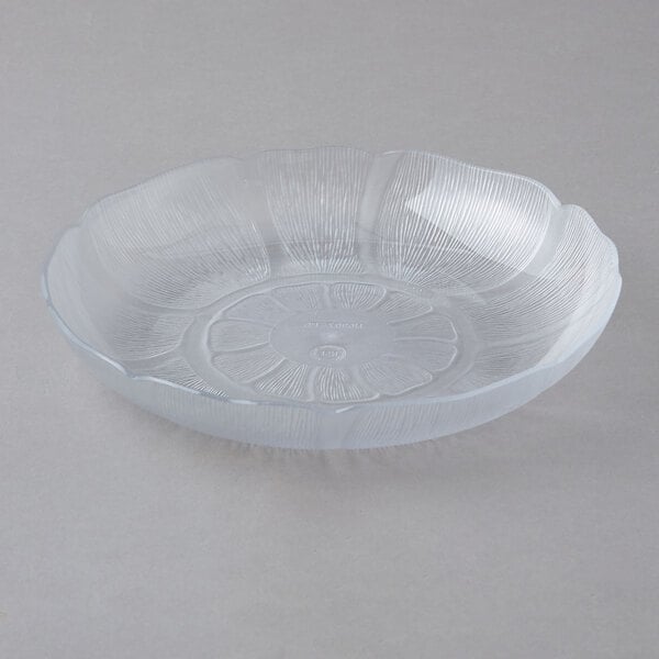A Carlisle clear polycarbonate plate with a flower design.