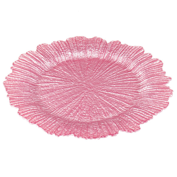 A pink Charge It by Jay glass charger plate with a textured flower pattern.