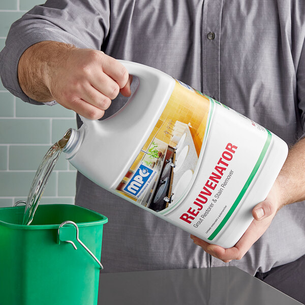 A person pouring Noble Chemical Rejuvenator into a green bucket.