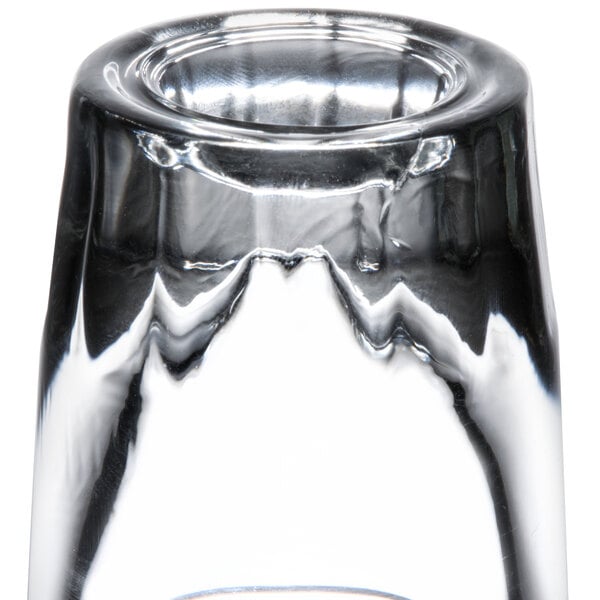A close up of a Libbey fluted shot glass filled with a small amount of liquid.