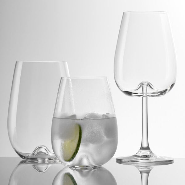 Three Stolzle Vulcano stemless wine glasses filled with ice and lime slices.