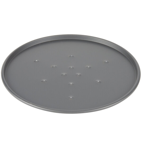 A Chicago Metallic BAKALON round metal pizza pan with holes.