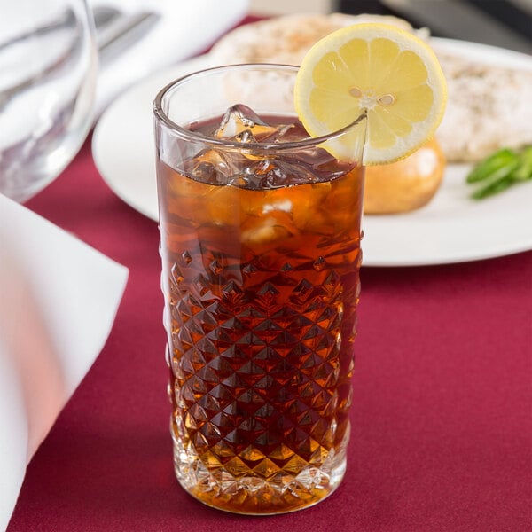 A Libbey Carats beverage glass filled with iced tea and a lemon slice.