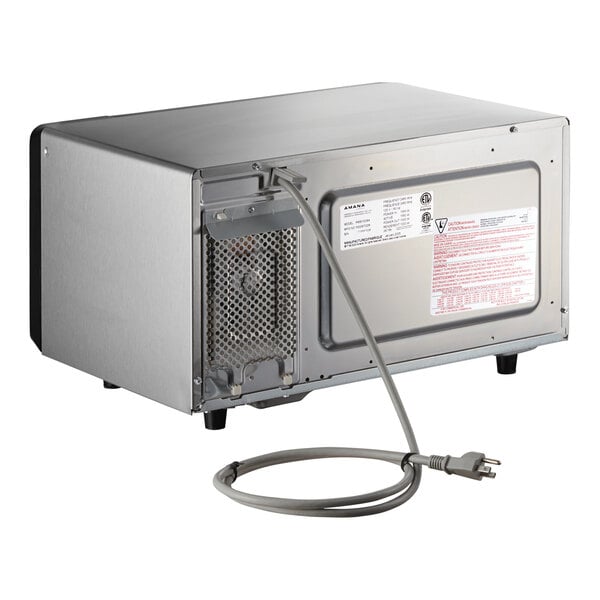 A stainless steel Amana commercial microwave with a cord.
