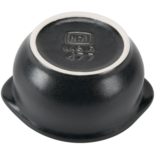 A black Hall China onion soup bowl with a white rim.