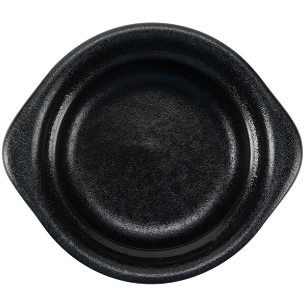 A close up of a black Hall China onion soup bowl.