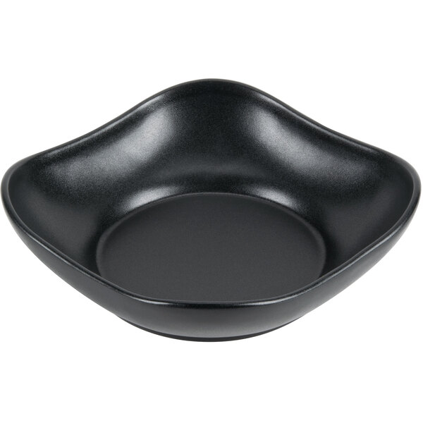 A black Hall China square bowl with scalloped edges.