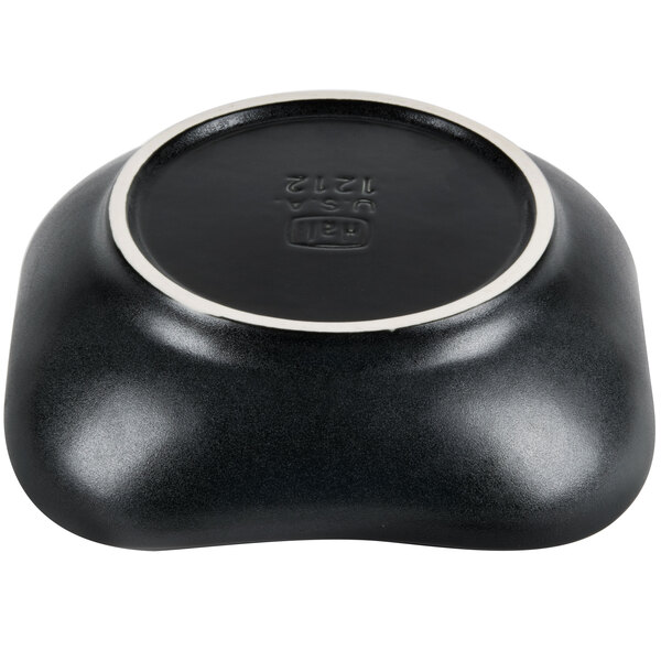 A black bowl with scalloped edges and a white rim.