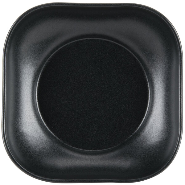 A black square Hall China bowl with a scalloped black rim.