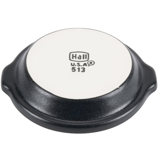 A white and black Hall China round au gratin dish.