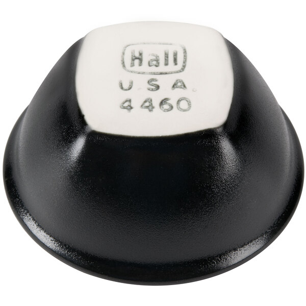 A black and white Hall China sauce dish with a white edge and white text.